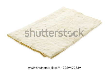 Delicious folded Armenian lavash on white background