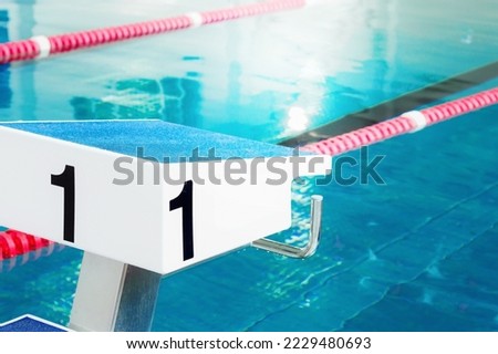 Starting table with numbers for diving in Olympic pool. Swimming pool for competitions with lane demarcation. Background.. Royalty-Free Stock Photo #2229480693