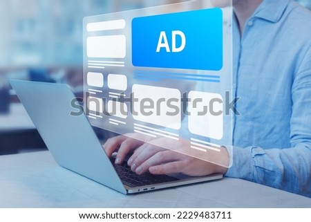 Programmatic in-feed advertisement on computer screen. Person viewing website with inbound ads to optimize click through rate and conversion. Digital marketing and online advertising to target client. Royalty-Free Stock Photo #2229483711
