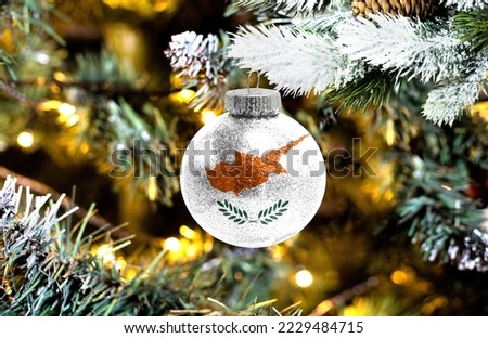 New Year's glass ball with the flag of Cyprus against a colorful Christmas background