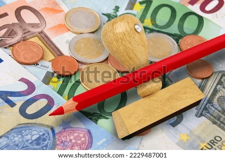 Euro banknotes and coins with stamp and red pencil
 Royalty-Free Stock Photo #2229487001