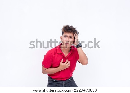 A scared man panicking, overwhelmed with dread and unsure of what to do. Unnerved and agitated, full of hysteria. Isolated on a white background. Royalty-Free Stock Photo #2229490833