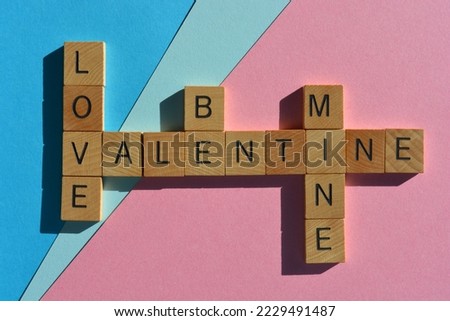 Love Be Mine Valentine, words in wooden alphabet letters in crossword form isolated on pink and blue background