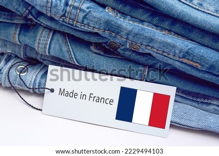 Detail of blue jeans, label and Made in France lettering. The concept of buying, selling, shopping and trendy modern clothes. Royalty-Free Stock Photo #2229494103