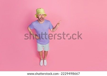 Full body photo high angle view of nice young guy point empty space discount dressed trendy blue clothes isolated on pink color background