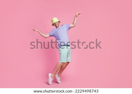 Full length photo of joyful dude boy enjoy party stand toes good mood empty space isolated on pink color background Royalty-Free Stock Photo #2229498743