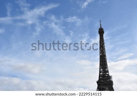 Eiffel Tower, icon of Paris, in a sunny day, blue sky background