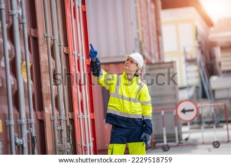 Engineer or foreman checking about shipping of container box in warehouse stock yard.