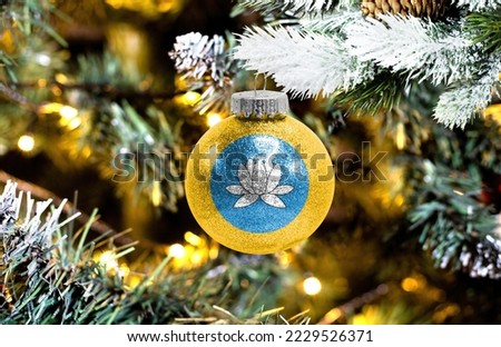 New Year's glass ball with the flag of Kalmykia against a colorful Christmas background