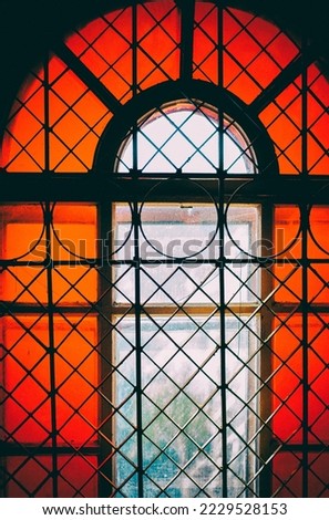 antique window with colored glass, stained glass, window in the old tower. High quality photo