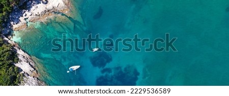 Aerial drone ultra wide panoramic photo of luxury sail boats anchored in tropical Caribbean rocky turquoise colour seascape