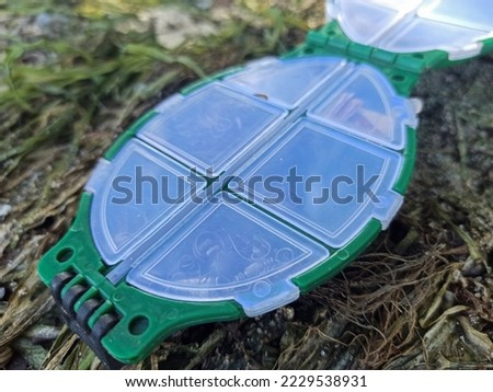 Fishing accessories isolated on green background. Close-up
