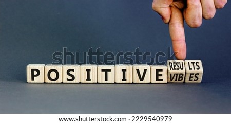 Positive vibes results symbol. Concept words Positive vibes or Positive results on cubes. Businessman hand. Beautiful grey table grey background. Business positive vibes results concept. Copy space