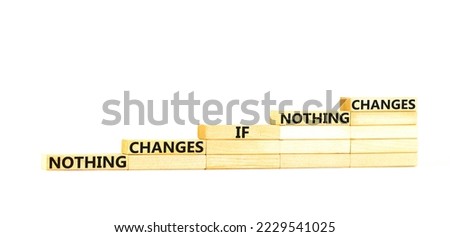 Nothing change symbol. Concept words Nothing changes if nothing changes on wooden blocks. Beautiful white table white background. Business nothing changes concept. Copy space.