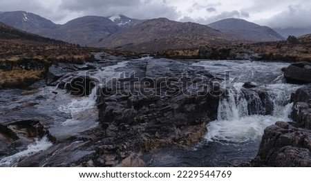 Waterfall with mountains in background