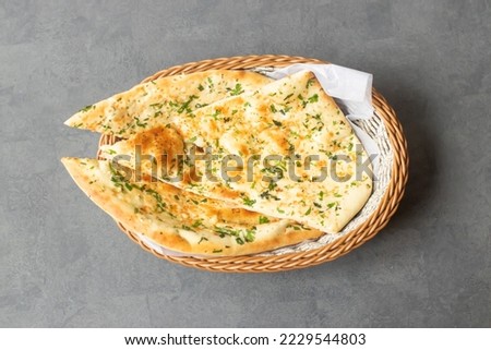 Tandoori Green Garlic Naan or bread served in basket isolated on table top view of asian and indian food Royalty-Free Stock Photo #2229544803