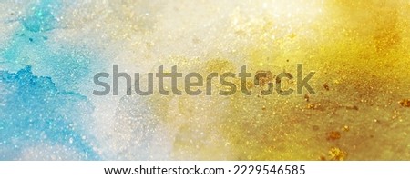 Abstract glittering background in gold and turquoise that looks like the surface of a pure planet with precious resources Royalty-Free Stock Photo #2229546585