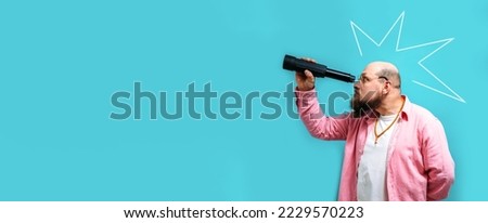 Crazy emotions. Young funny hipster tourist looking through a spyglass and considering the sights isolated on studio background. Looking for discounts, sale, seasonal sales. Colorful summer concept. Royalty-Free Stock Photo #2229570223