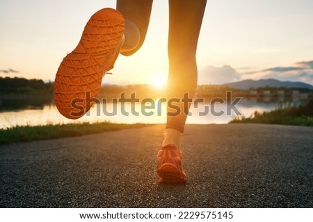 Woman runs in the park on autumn morning. Healthy lifestyle concept, people go in sports outdoors. Silhouette family at sunset. Fresh air. Health care, authenticity, sense of balance and calmness.