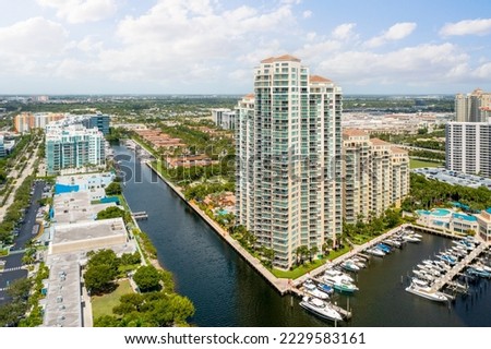 Aerial drone view of miami bay with city in the background, blue sky, tropical greenery with trees and palms
