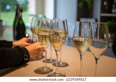 Tasting of brut and reserve grand cru champagne sparkling wine produced by traditional method in underground caves in Champagne, France, close up