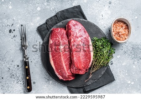 Raw top blade flat Iron beef organic meat. Gray background. Top View. Royalty-Free Stock Photo #2229595987