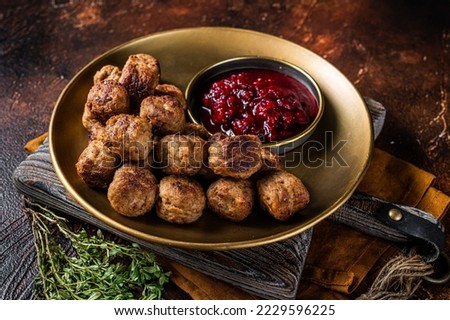 Beef meatballs with lingonberries jam, swedish meatballs. Dark background. Top view. Royalty-Free Stock Photo #2229596225