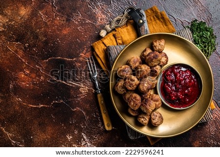 Beef meatballs with lingonberries jam, swedish meatballs. Dark background. Top view. Copy space. Royalty-Free Stock Photo #2229596241