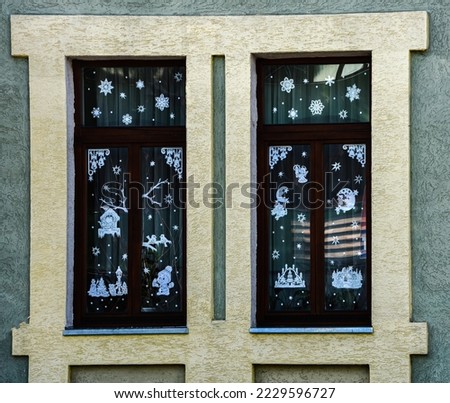 Christmas decoration with paper on the Windows with handcrafted ornaments. Christmas decoration on the Windows. Christmas decoration on the Windows is made of paper