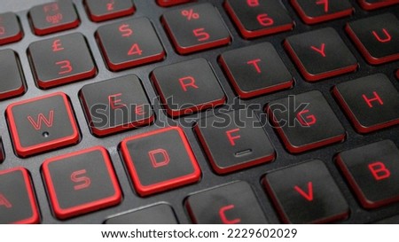 Backlit keyboard Close-up. Black Keys With Red Backlit Characters.