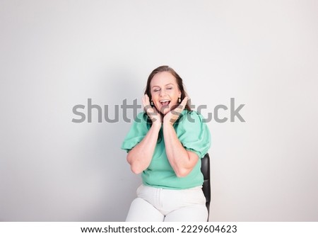 Beautiful mature woman with surprised and happy expression