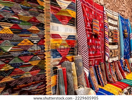 Colorful moroccan carpets with oriental ornaments for sale on a street shop in Kasbah Ait Ben Haddou near Ouarzazate in the Atlas Mountains of Morocco. Artistic picture. Beauty world.
