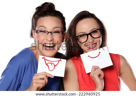 Two girls with glasses posing with a smile on paper