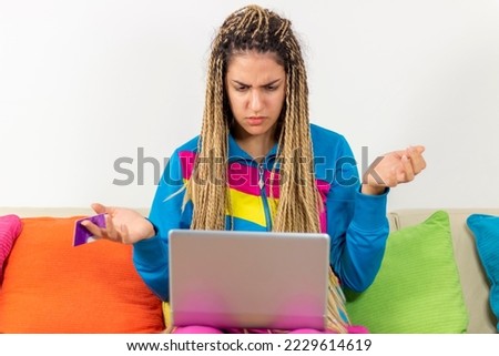 Concerned annoyed teenager girl staring at laptop screen with angry face, having problems with software, online app, banking service, getting bad news, feeling stress about connection errors