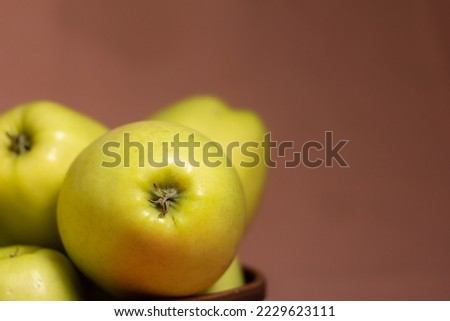 Close-up of fresh juicy golden apples with blurred background