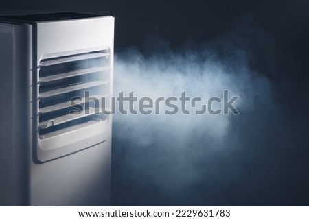 louvers outlet of portable air conditioner with cold steam, close-up view