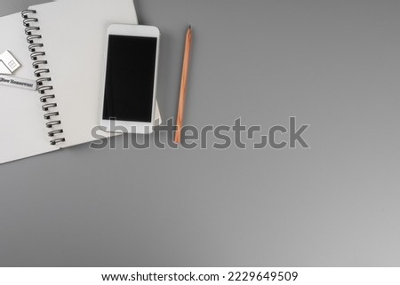 Top view accessories office concept. Mobile phone, notepaper,pen on office desk.
