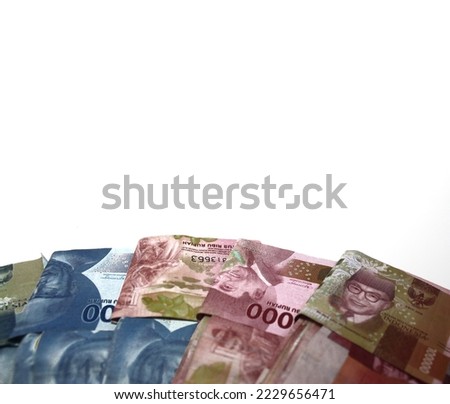 Selective focus of Indonesian money or rupiah, with a value of a hundred thousand rupiah (red) and fifty thousand rupiah (blue). White isolated background.