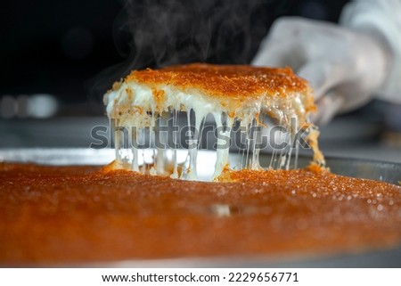 Traditional Turkish dessert kunefe. Kanafeh concept with cheese and pistachio  Royalty-Free Stock Photo #2229656771