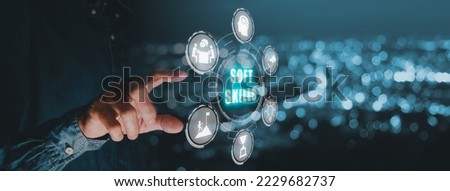 Soft skills training and improvement concept, Businessman hand holding VR screen Soft skills icon on blue bokeh background. Royalty-Free Stock Photo #2229682737