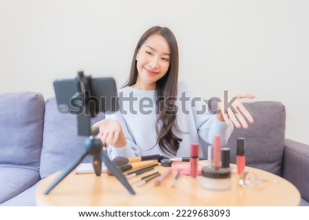 Portrait beautiful young asian woman review cosmetic make up online at home Royalty-Free Stock Photo #2229683093