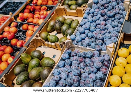 Plum, avocado and other fruits for sale in supermarket or at farmers market