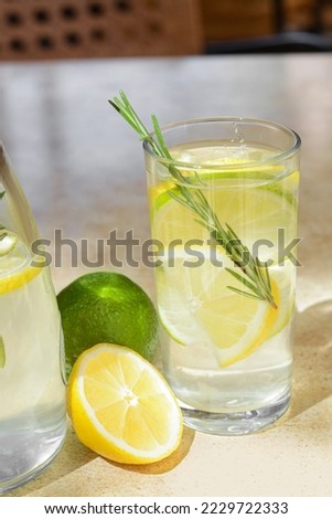 Tasty refreshing lemonade and ingredients on light table. Summer drink
