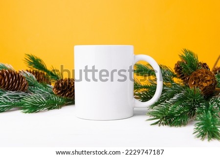 White ceramic mug with copy space with Christmas tree, front view. Mockup for applying a logo, drawing for the holiday.