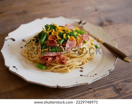 Pasta with canola flower and bacon seasoned in Japanese style