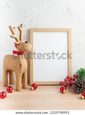 White blank wooden frame mockup with Christmas decorations  on the wooden table.  Frame for quotes. Christmas postcard.
