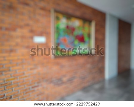Blurred picture of a painting on the brick wall of the office building. No people