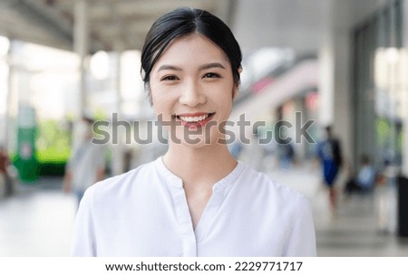 Happy smiling young woman on the street