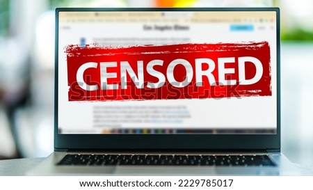 Laptop computer displaying the sign of censorship on an internet news site Royalty-Free Stock Photo #2229785017