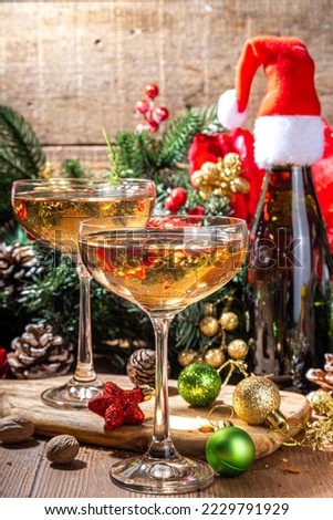 Merry Christmas and New Year holiday celebration with champagne. on wooden table with Christmas tree and decoration 